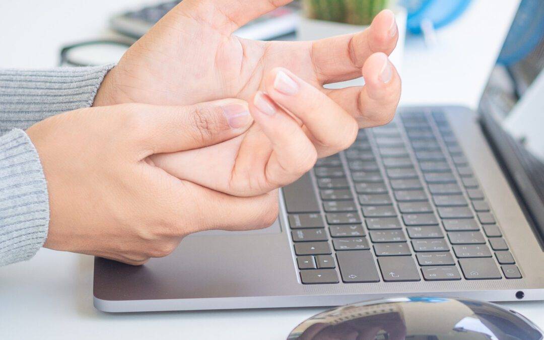 Closeup woman holding her hand pain from using computer long tim